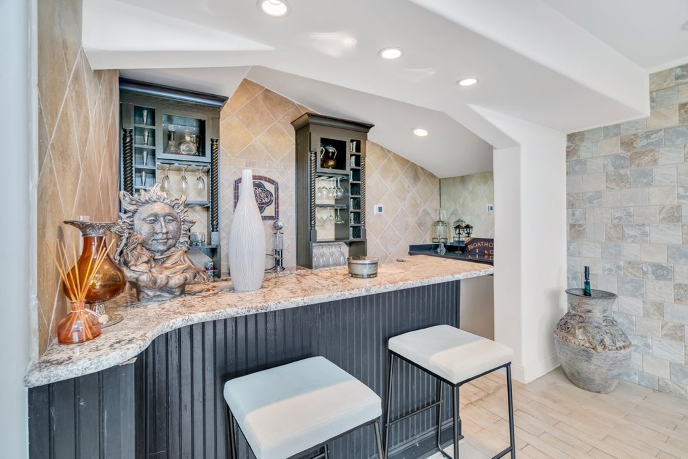 Living room featuring two large sofas, a chaise, dining for 10 at the table, and a full service wet bar.