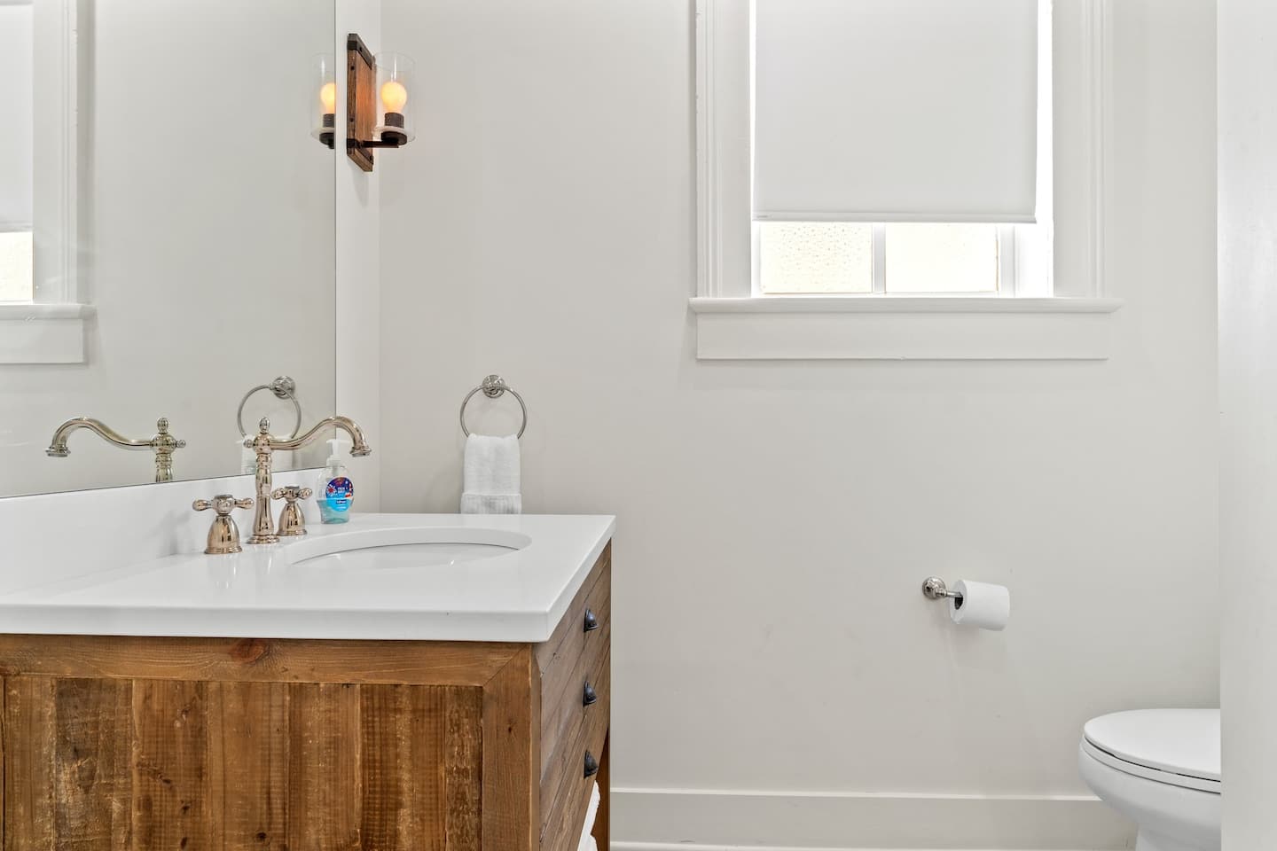 First bathroom with spacious shower and large mirror provided