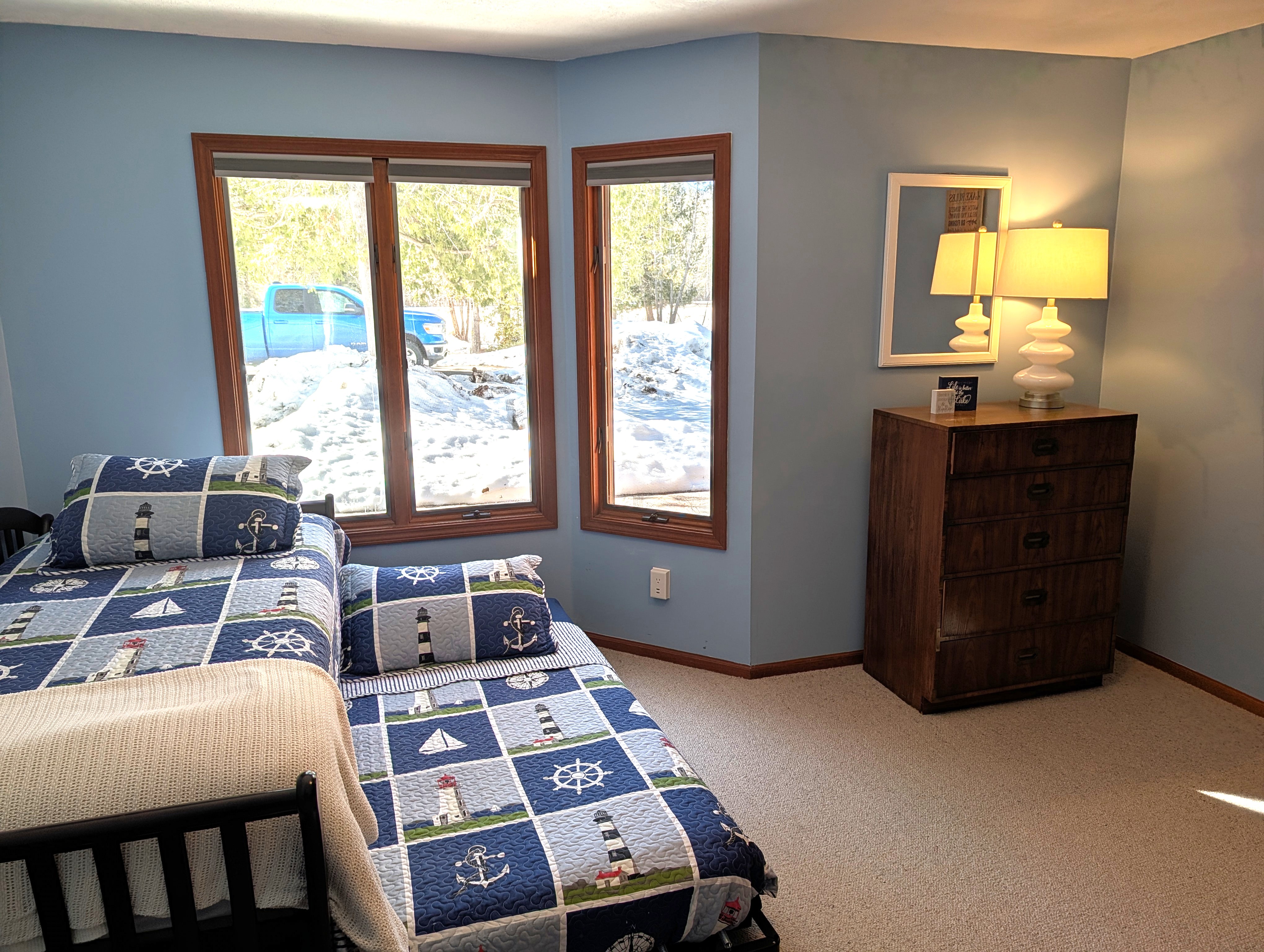 BEDROOM #1 (FIRST FLOOR):  There is a small bedroom with a trundle bed on the first floor.  Includes a closet, dresser, and mirror as well.