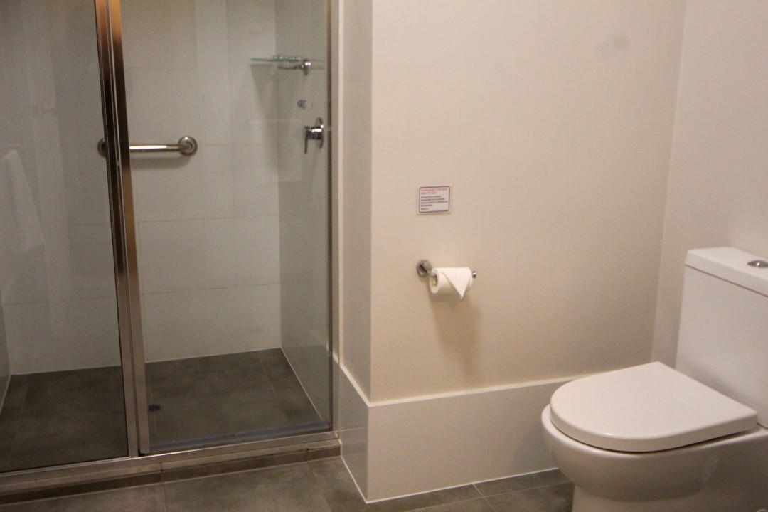Coin-operated communal laundry (washer, dryer, ironing) with linen and towels provided for guest convenience