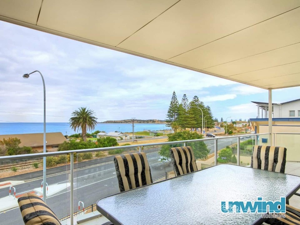 Panoramic Ocean Views from the Penthouse. Spectacular, elevated outlook over Encounter Bay and Granite Island from a private balcony — a consistent value-driver in coastal holiday rentals.
