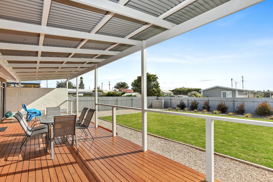 Expansive covered back deck offers uninterrupted, panoramic views of iconic sand dunes, creating a stunning natural backdrop.