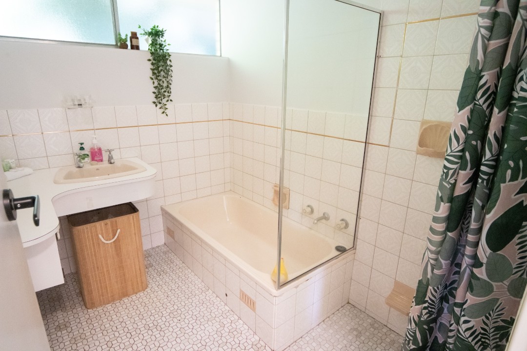 The main bathroom is centrally located on the lower level, providing easy access from all four additional bedrooms.  It includes a full-size shower and bathtub—ideal for winding down after a day at the beach or pool