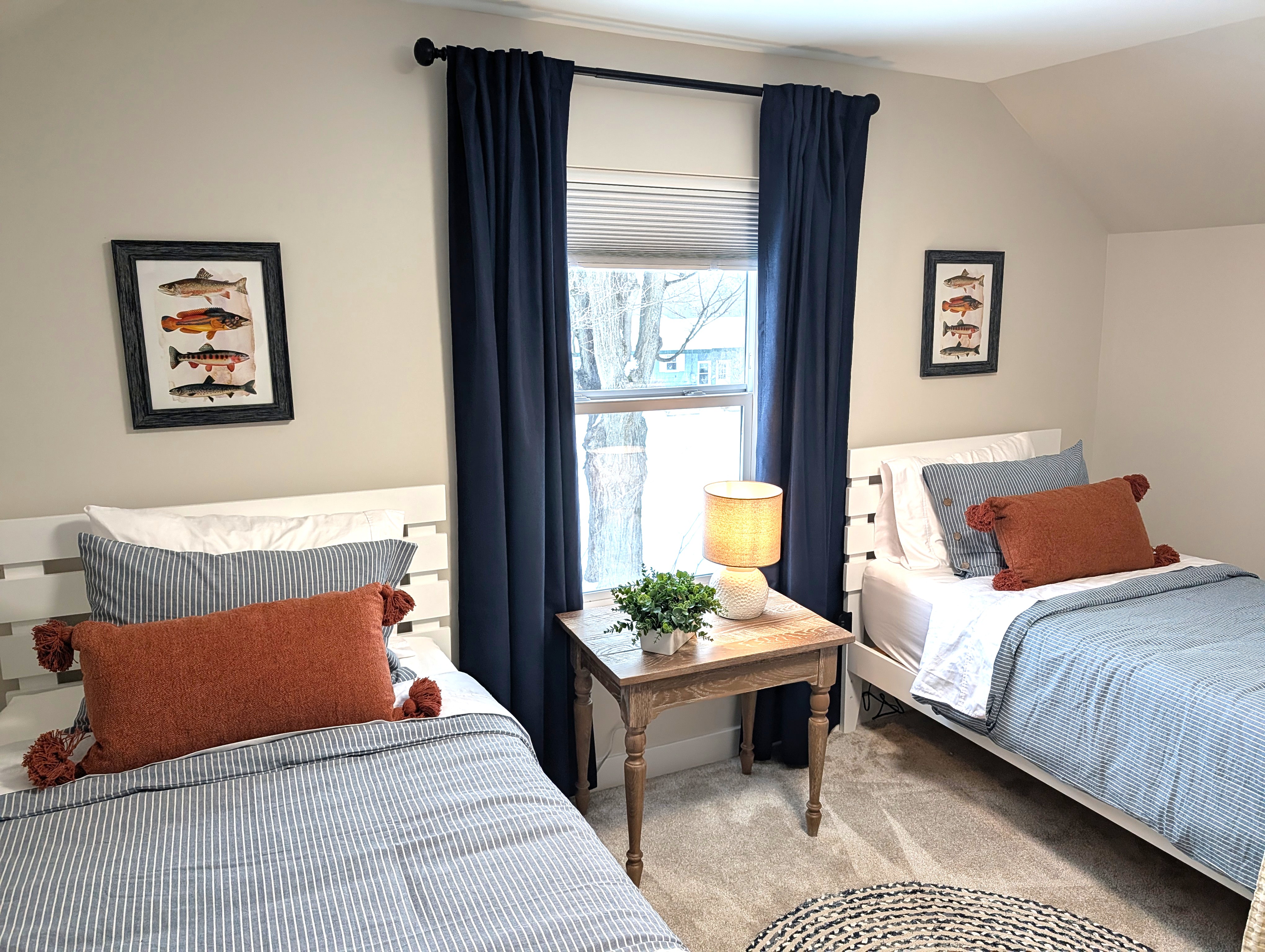 BEDROOM #2 (SECOND FLOOR):  Cute bedroom with two twin beds, table, lamp, dresser, and closet.