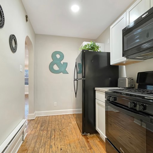 Full galley style kitchen with fridge, stove, oven, and dishwasher