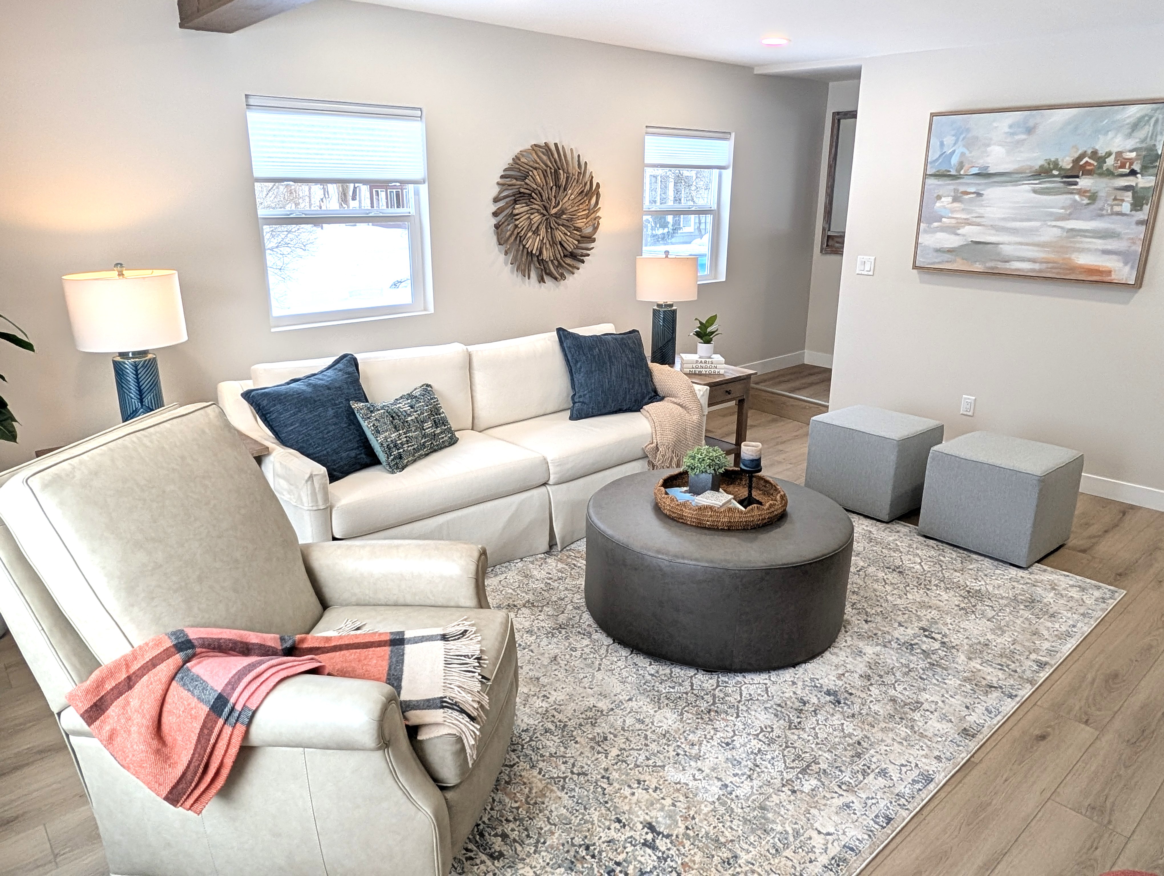 LIVING ROOM:  The home has a gorgeous newly-decorated living room with a sofa, comfy chairs, ottoman, and large screen television