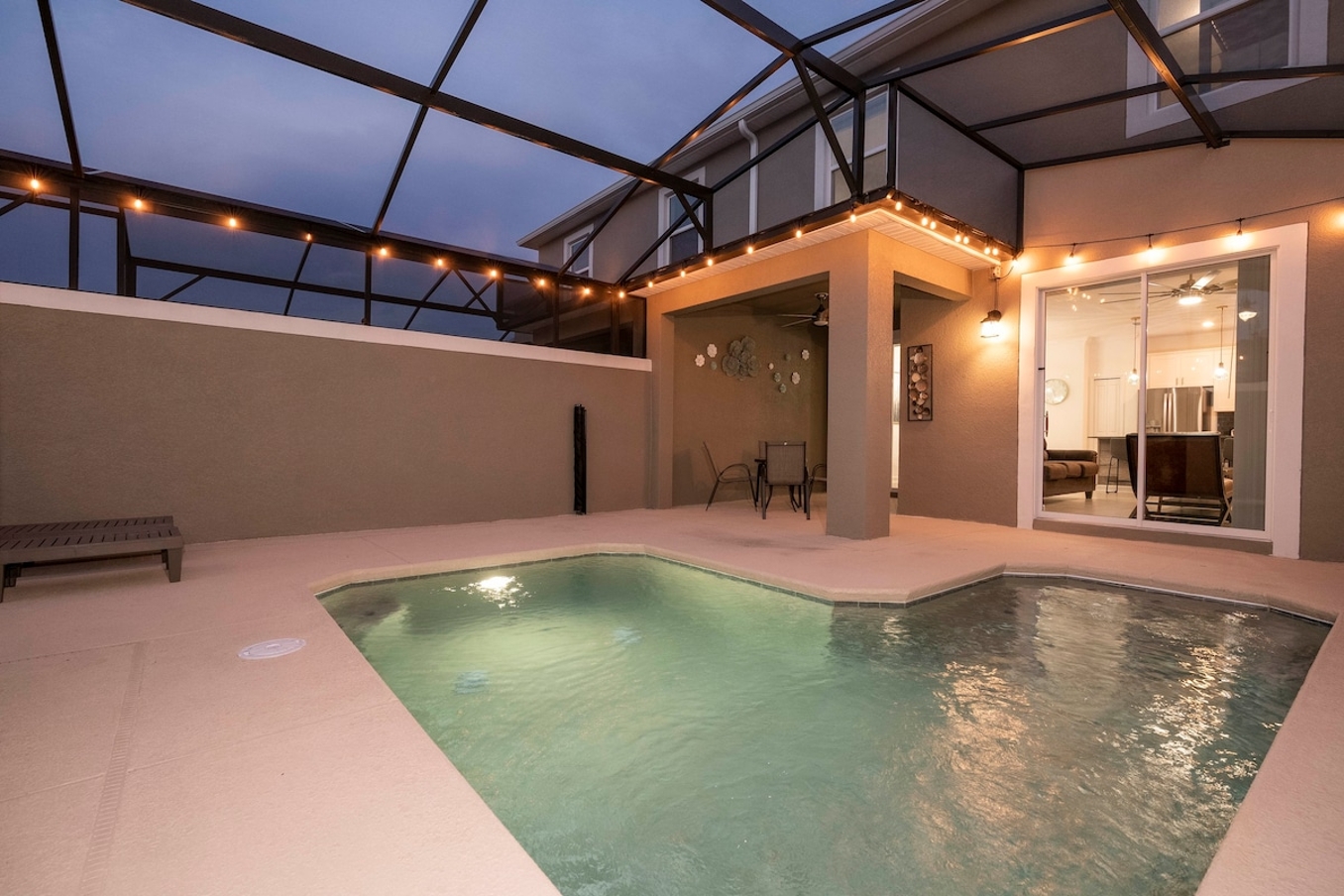 Enjoy a screened private pool with a BBQ grill and comfortable outdoor furniture, perfect for relaxing and dining al fresco.