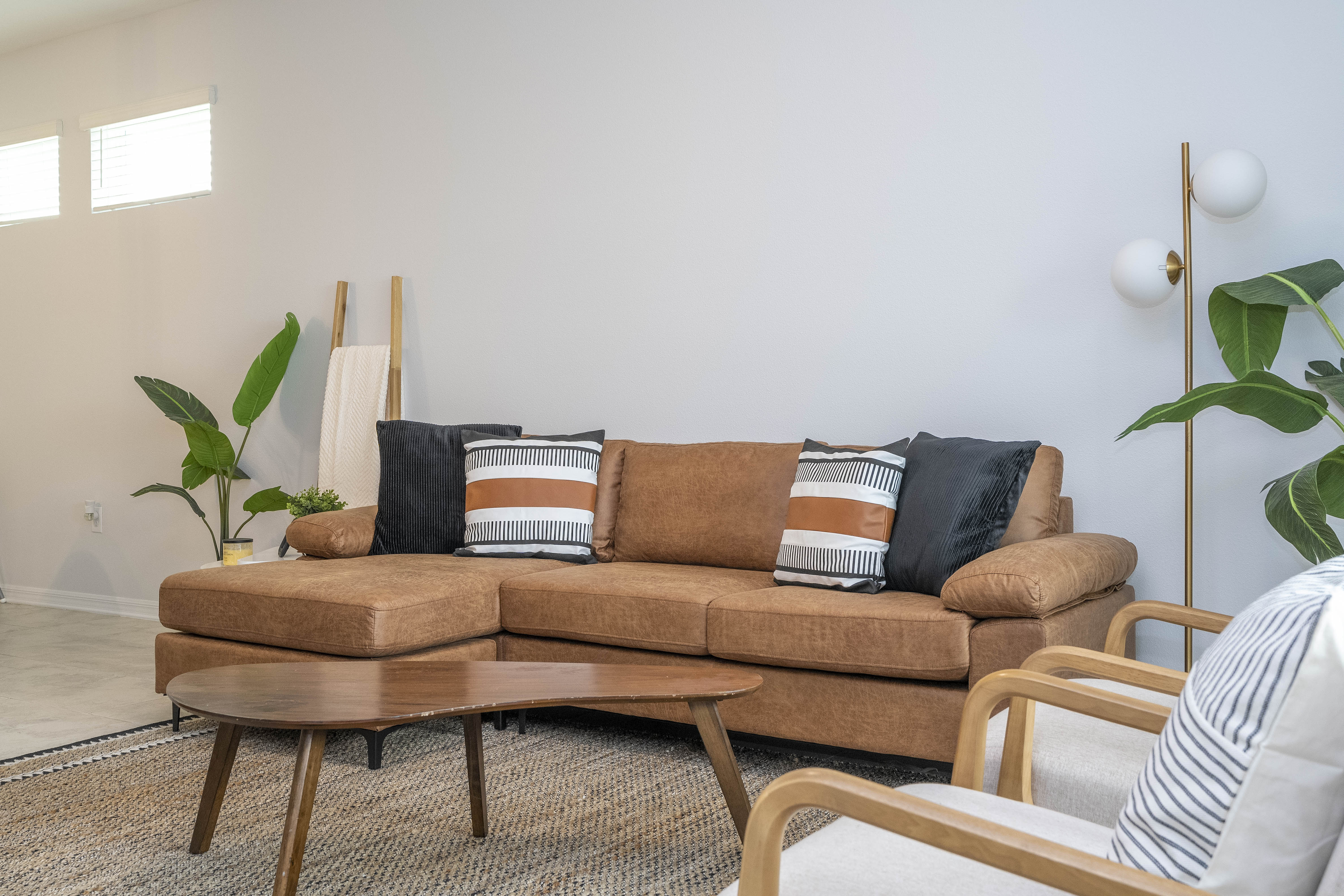 Step into this spacious, comfortable living area. The expansive room is adorned with tasteful decor, offering a blend of modern aesthetics and homey warmth. 