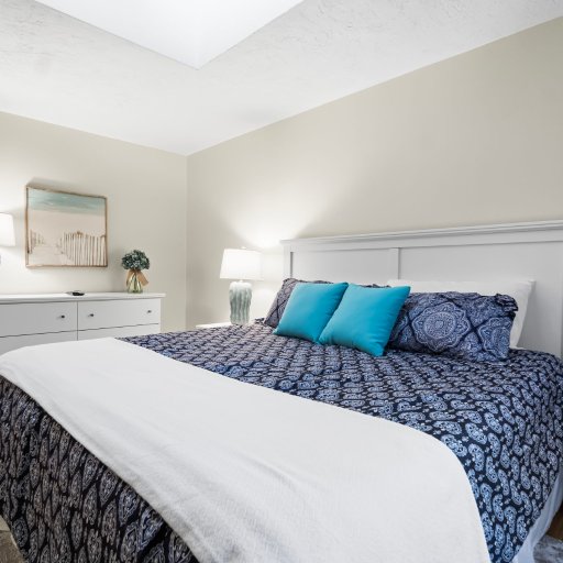 Bedroom 2: king bed, dresser, and skylight.