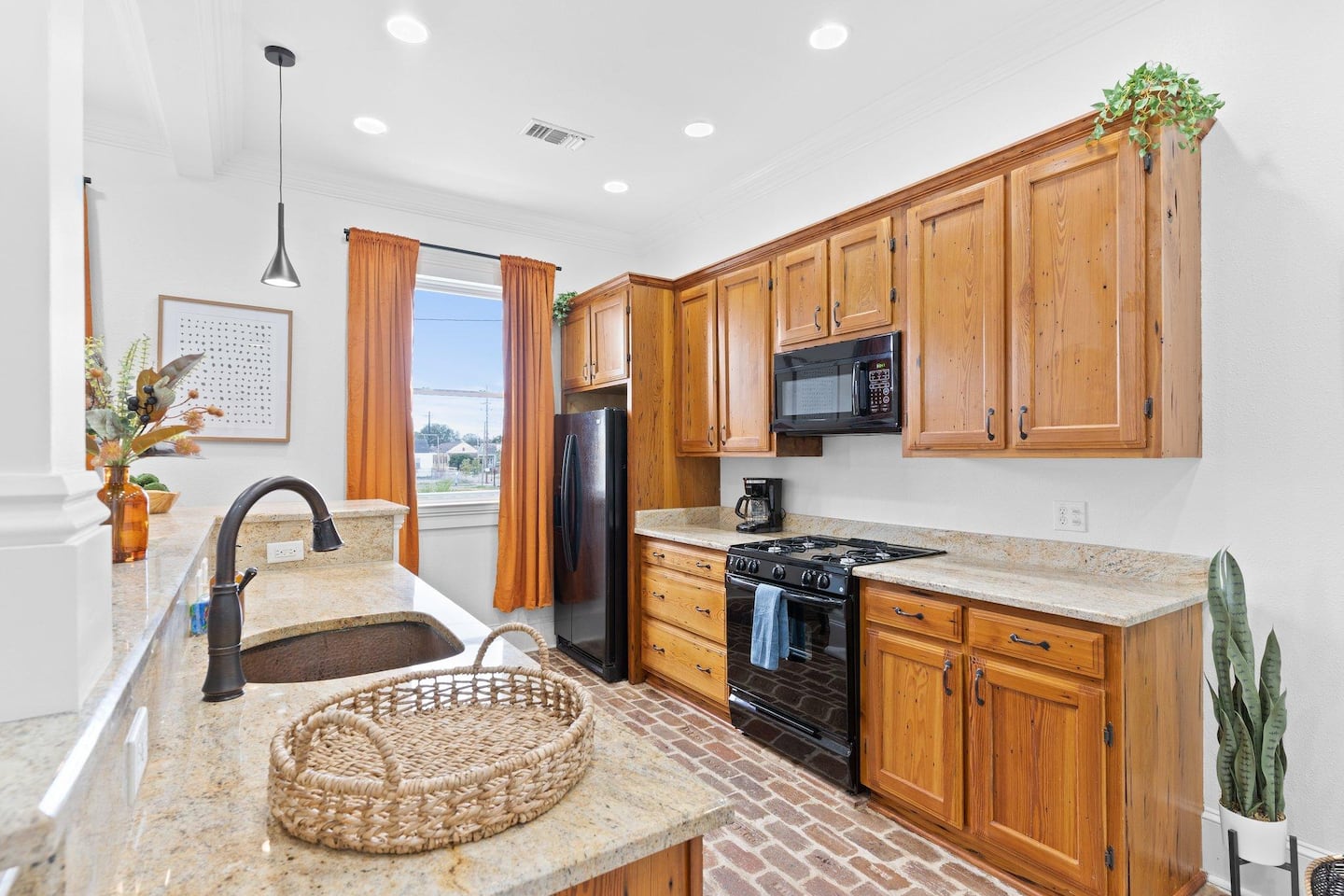 Fully stocked kitchen with Fridge, microwave, dishwasher, and stove/oven. Custom cabinets made from Barge Board! Brick floors! No detail was spared in this historic renovation!