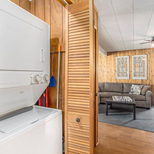 Stacked washer and dryer off the hallway