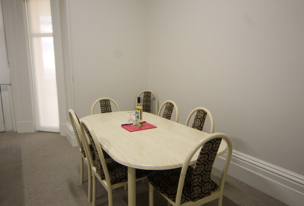 A full-sized dining table provides the perfect setting for shared meals, celebrations, or planning the next day’s adventures. (Wine pictured is for styling purposes only.)