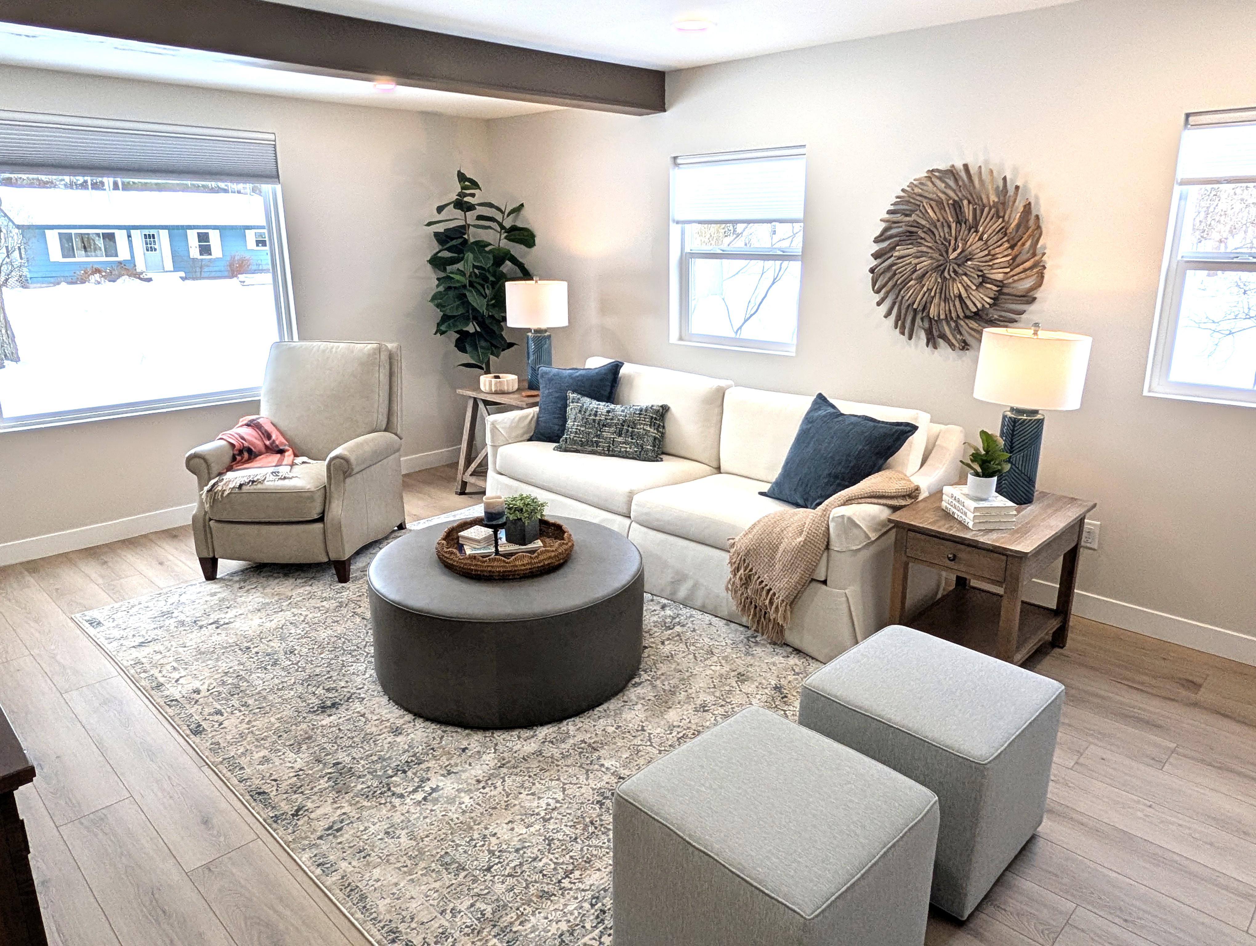 LIVING ROOM:  The home has a gorgeous newly-decorated living room with a sofa, comfy chairs, ottoman, and large screen television