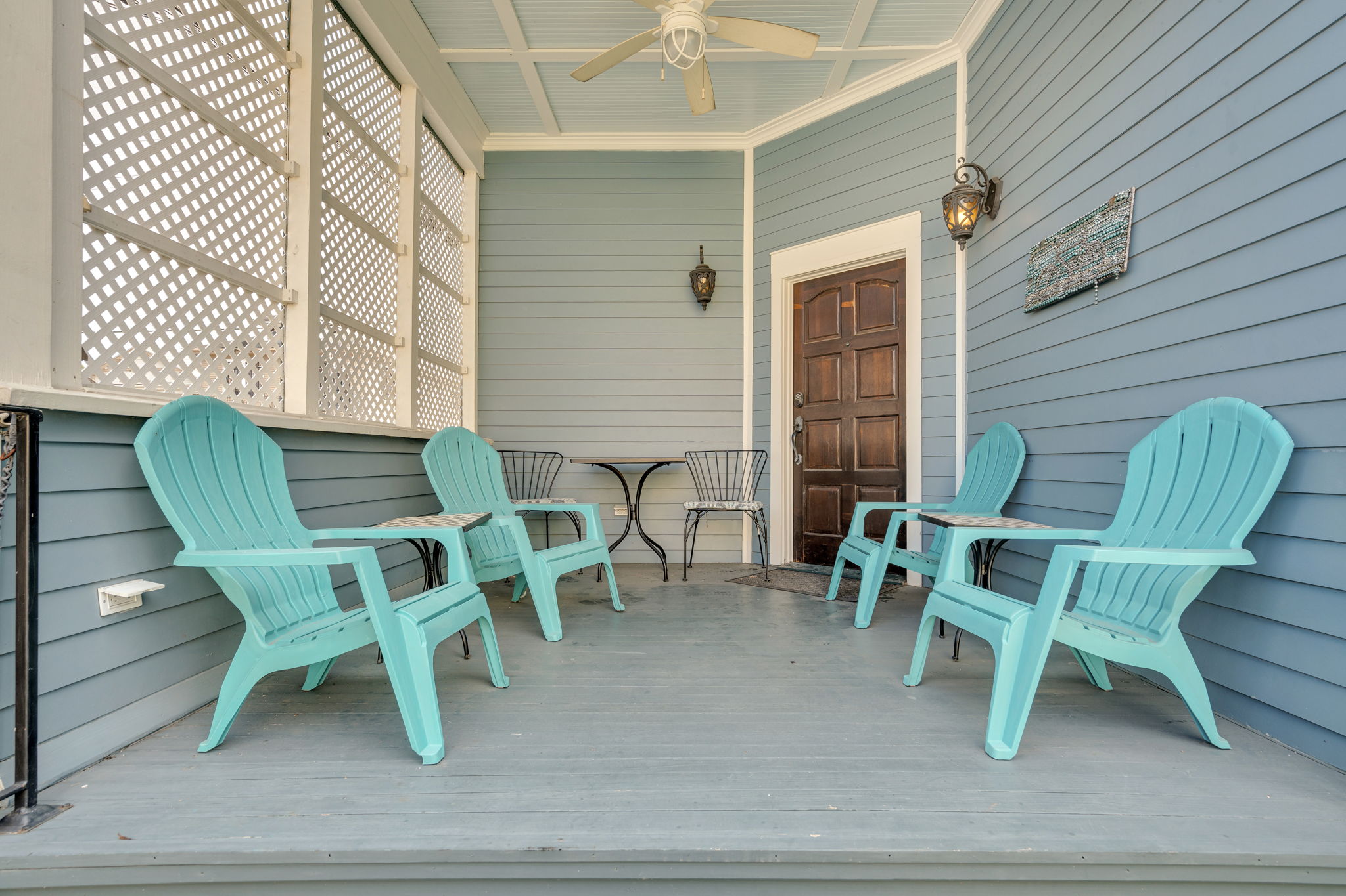 Classic New Orleans porch with cozy seating for morning coffee.
