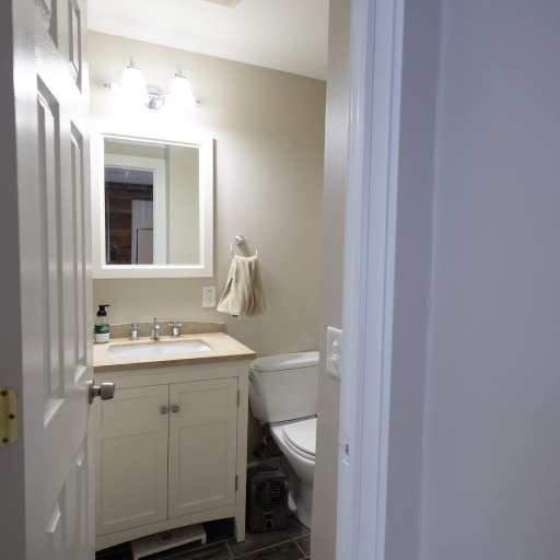 Modern third bathroom with a bright, clean design, featuring a spacious vanity and fresh towels for your convenience