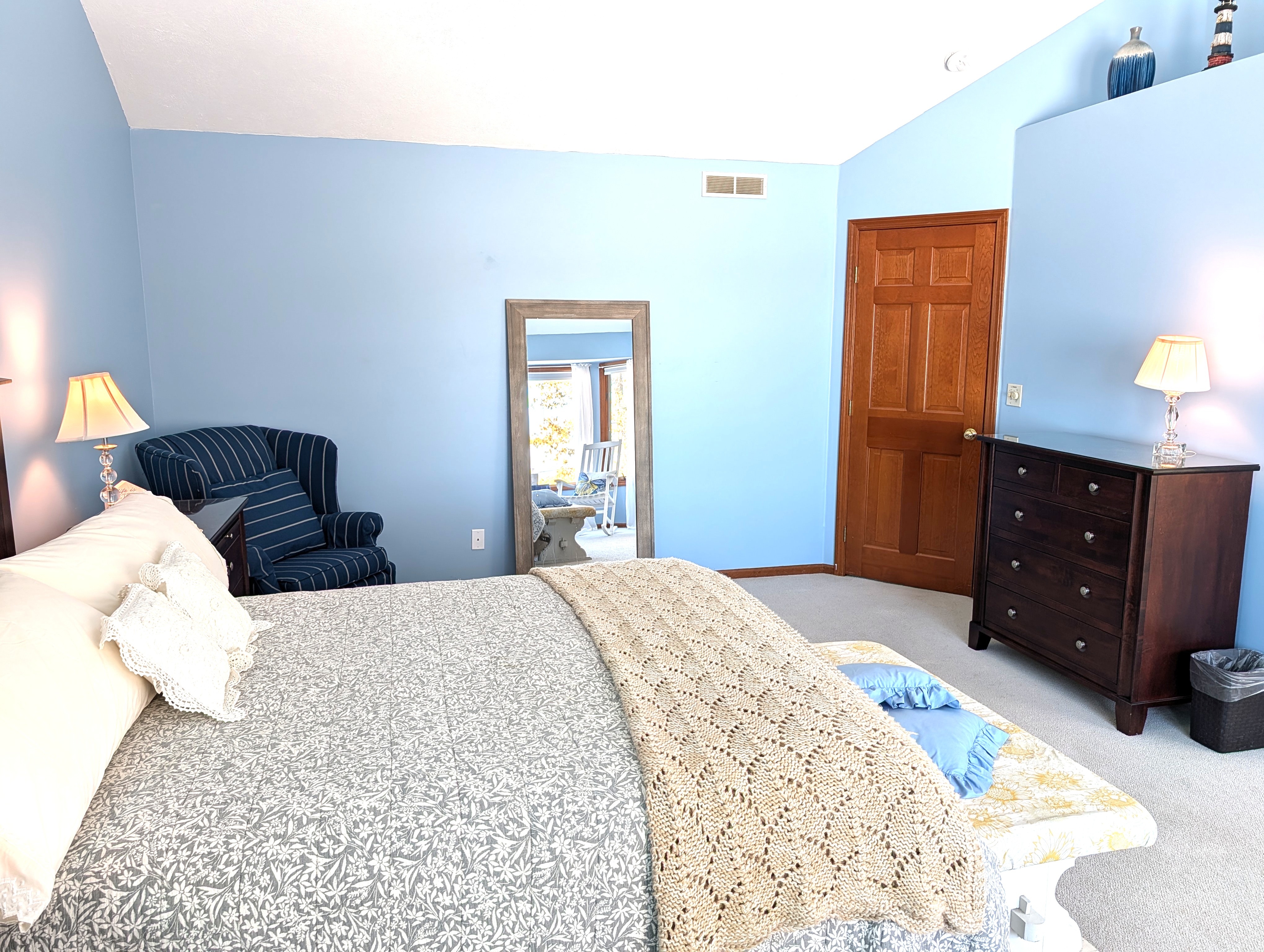 BEDROOM #2 (SECOND FLOOR):  The home has a huge primary bedroom on the second floor with a queen-size bed, private ensuite bathroom, and great views of Big Platte Lake!