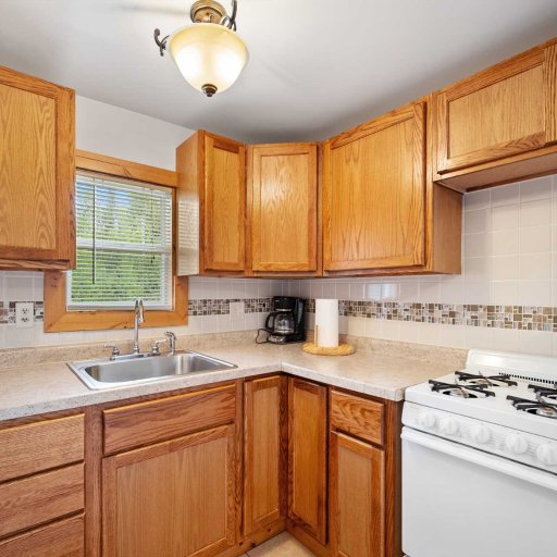 Fully stocked kitchen with stove, fridge, coffee maker, and cookware for meals in