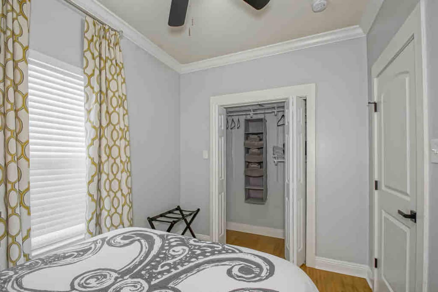 First Bedroom with smart tv, luggage rack, closet organization