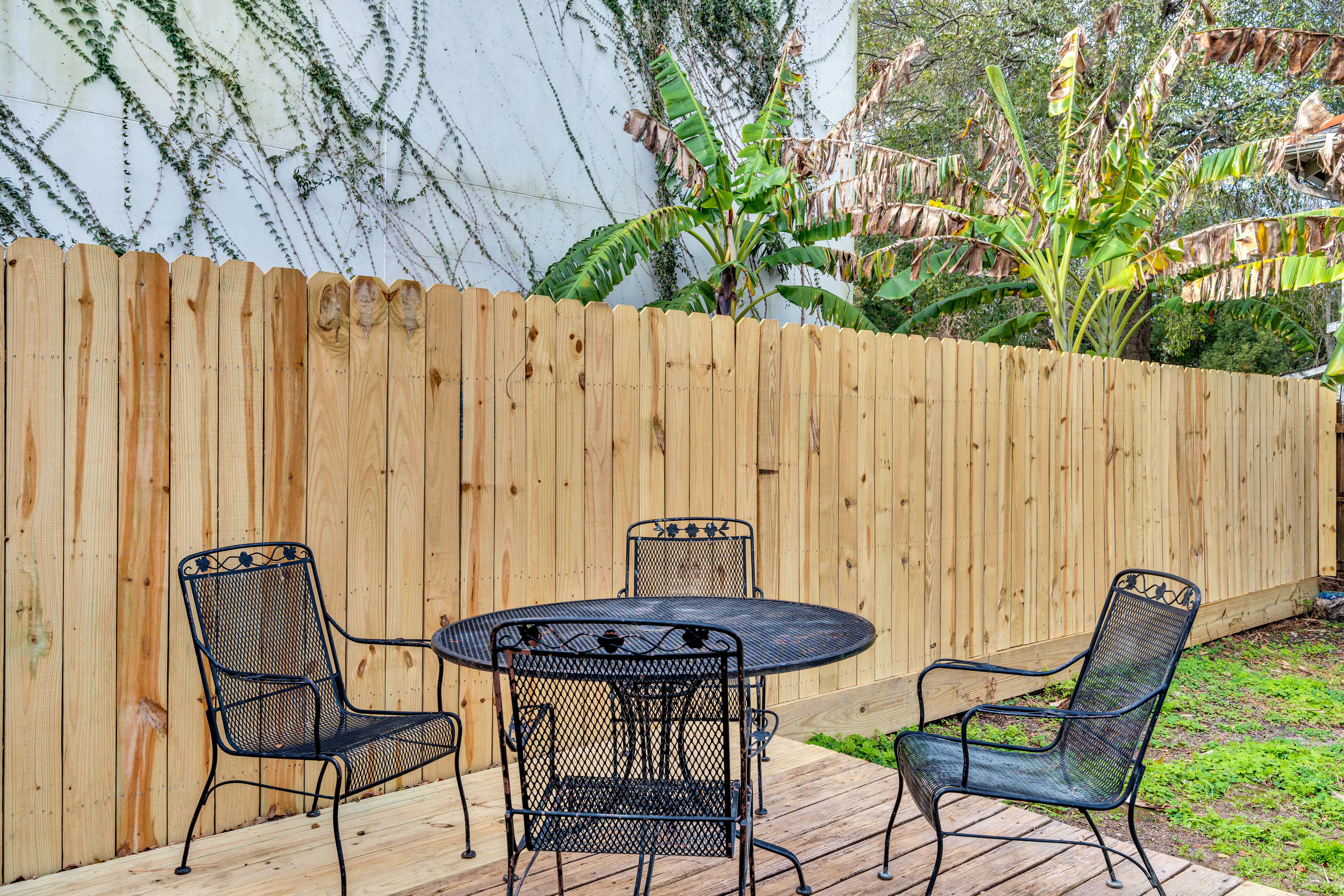 Outdoor dining table in fenced yard