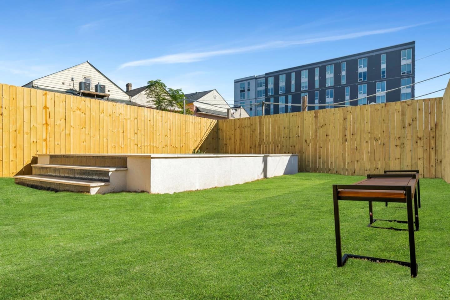 Fully-Fenced Pool with pool toys, towels, and lounge chairs