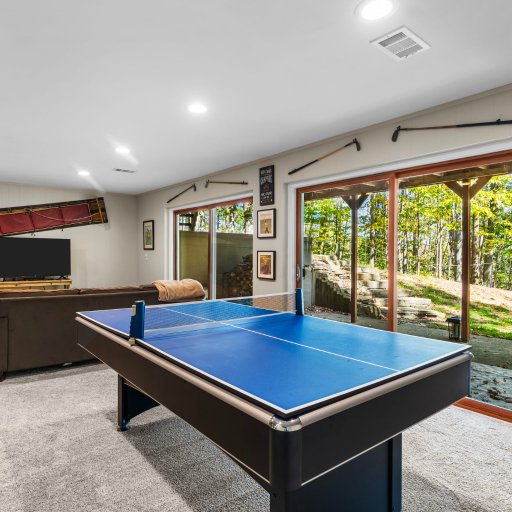Cozy game room with pool/ping pong table and views.