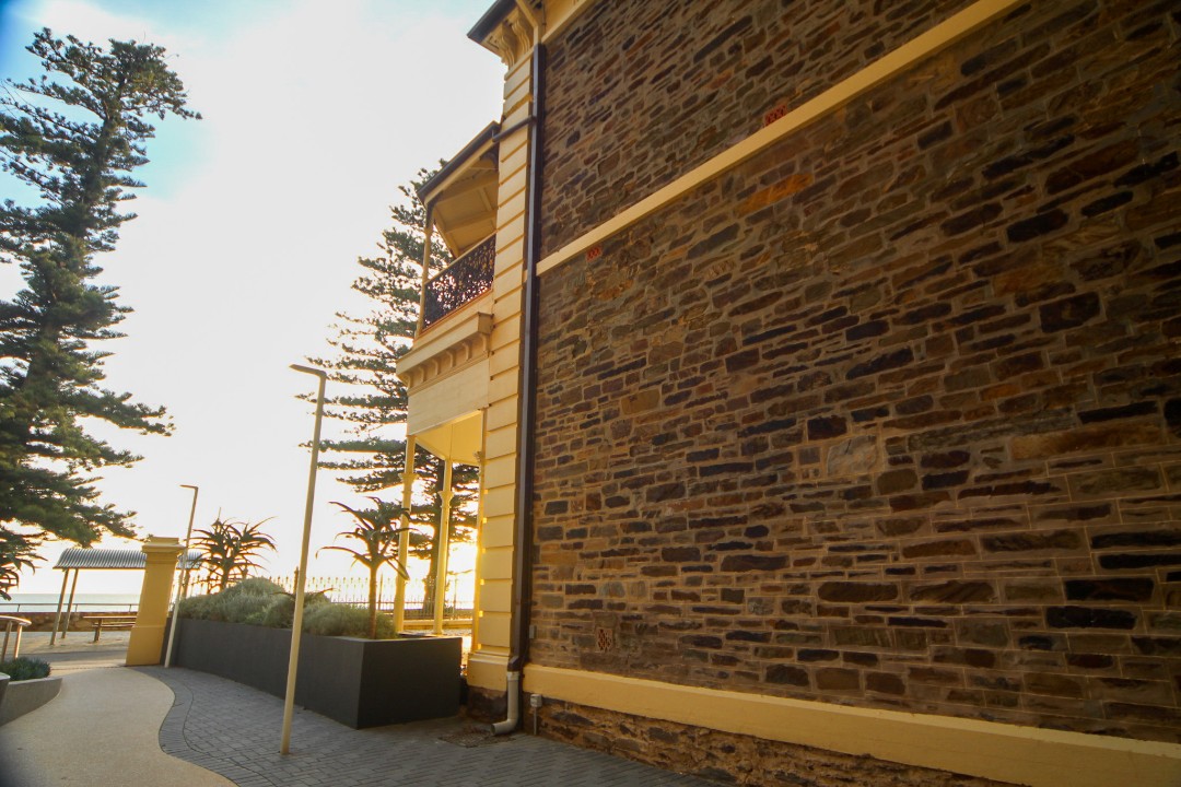 A rare opportunity to stay in a fully restored Circa 1876 building with original features like high ceilings, ornate rosettes, and heritage stone walls.