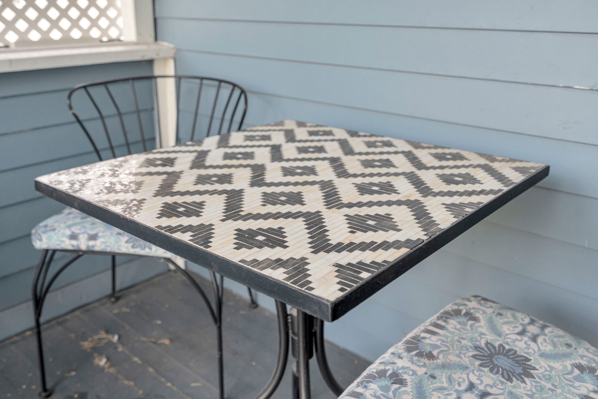 Relax on the porch with coffee at this cozy outdoor table