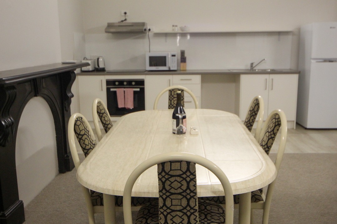 A full-sized dining table provides the perfect setting for shared meals, celebrations, or planning the next day’s adventures. (Wine pictured is for styling purposes only.)