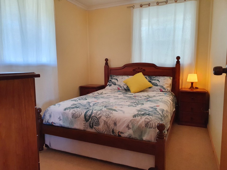 Three well-appointed bedrooms, including two queen beds and two tri-bunks, catering to families, couples, and small groups with ease.