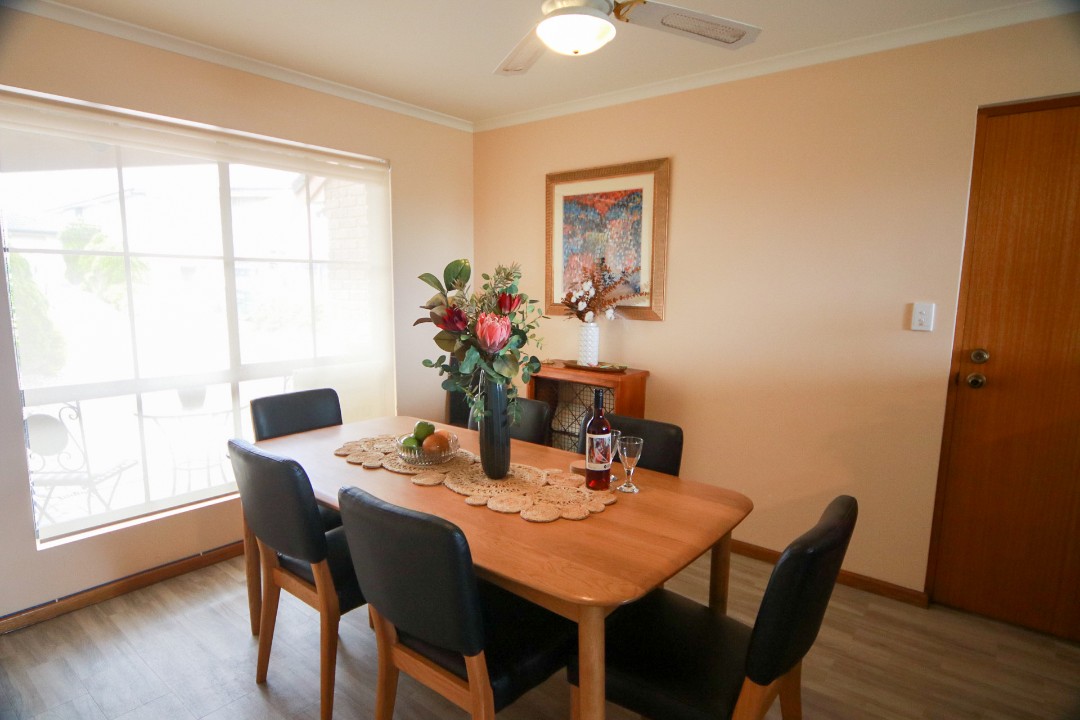 The dining space invites family meals, game nights or shared conversations with sea breeze ambiance. (Wine pictured is for styling purposes only.)