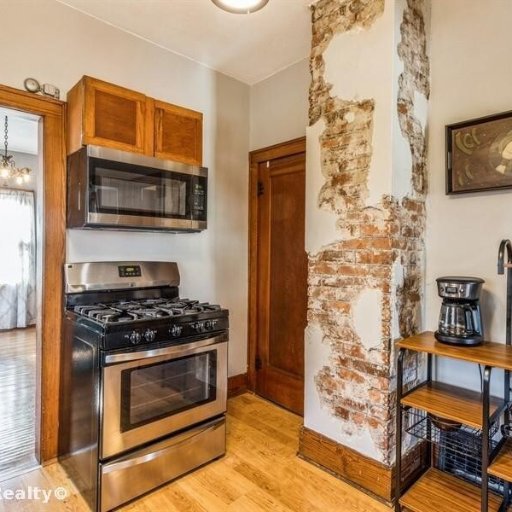 Artisan Exposed Brick in Kitchen with modern touches like stainless appliances.