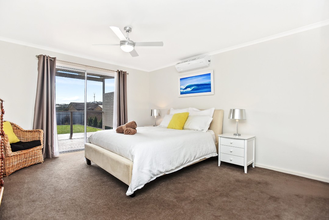 Each bedroom is fitted with queen-size beds, built-in robes, ceiling fans, and the master features reverse cycle air conditioning plus direct deck access.