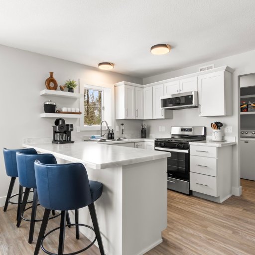 Fully equipped kitchen with breakfast bar seating for three