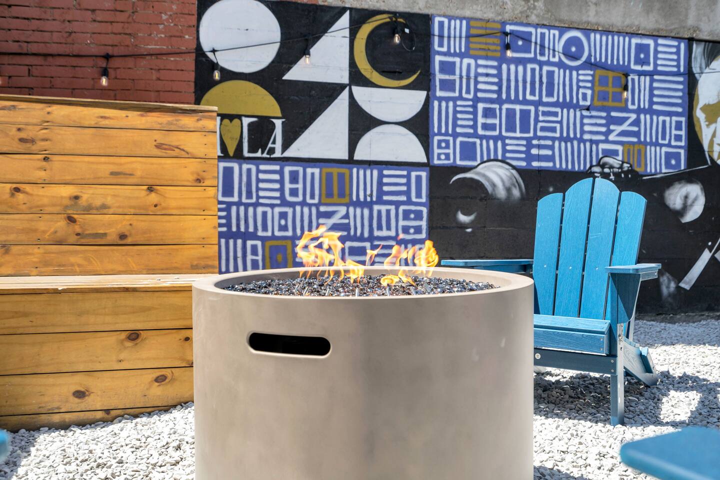 Urban hangout with fire pit seating and bold, local street art.