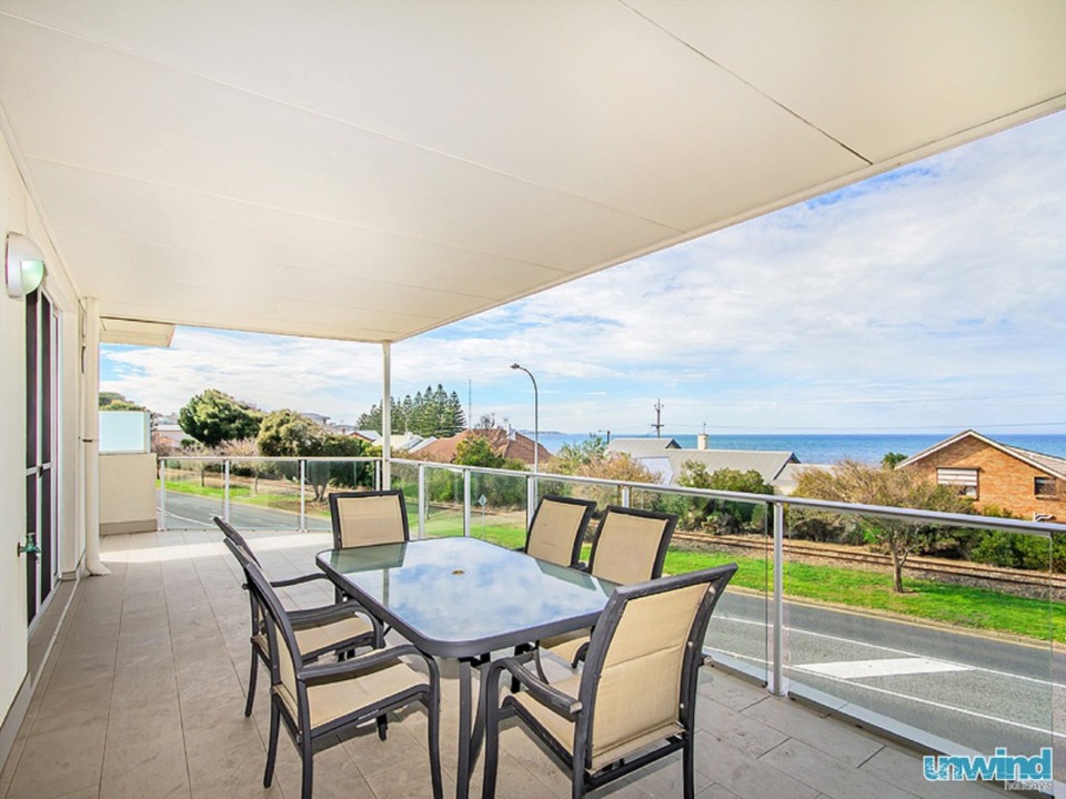Located on the top floor with a private balcony offering uninterrupted, elevated ocean vistas.