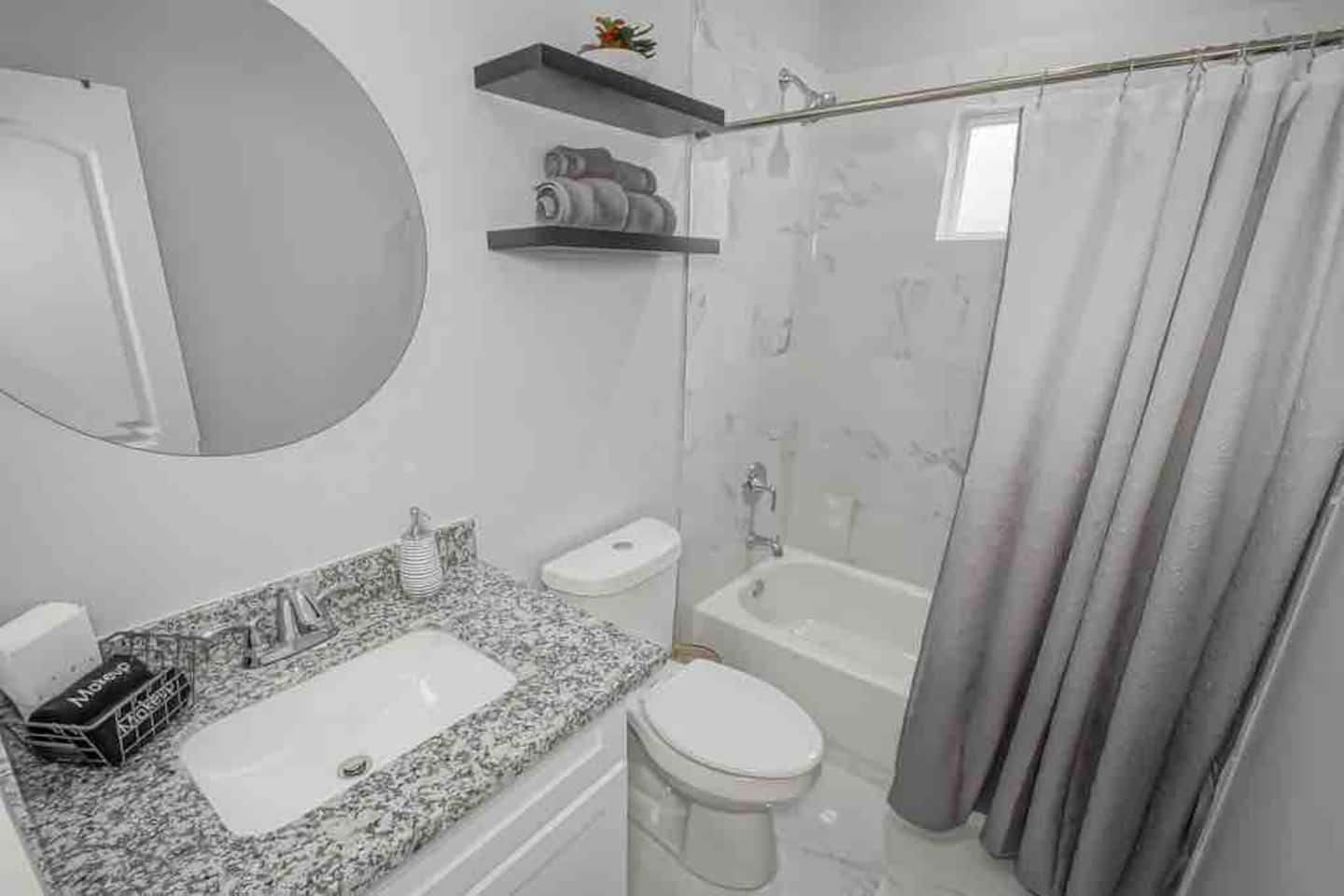 Guest bathroom with makeup towels and hair dryer in vanity