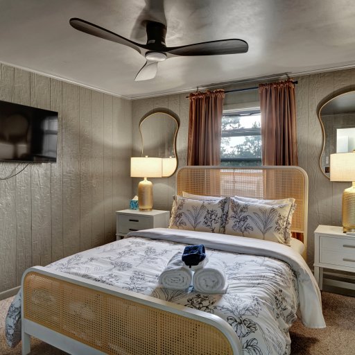 Thoughtfully styled queen bedroom with comfortable bedding and quiet ambiance.