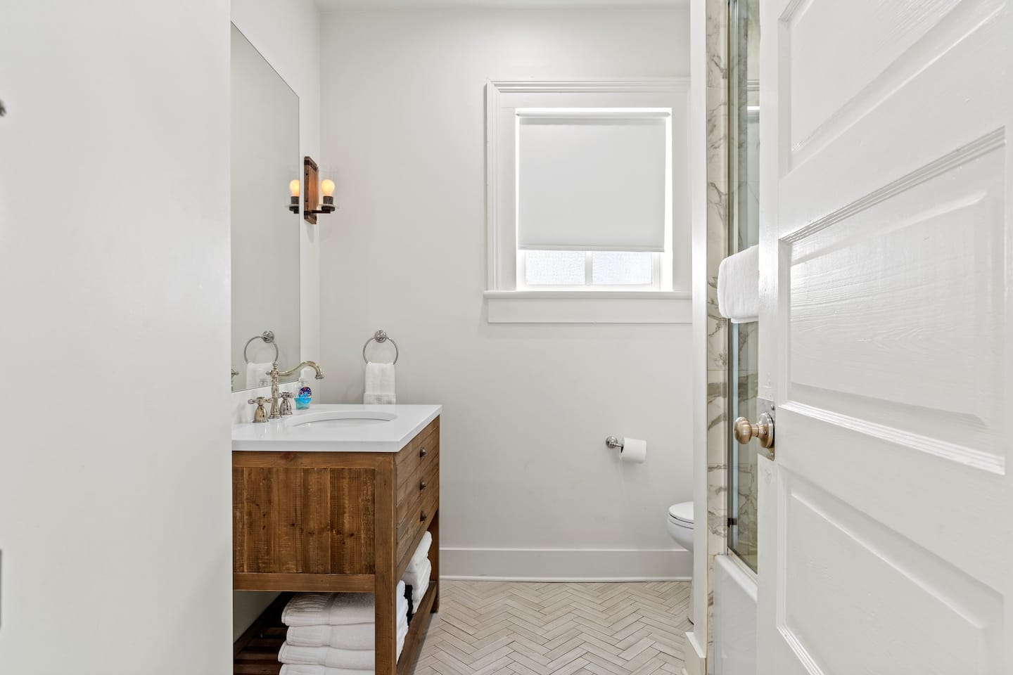 First bathroom with spacious shower and large mirror provided