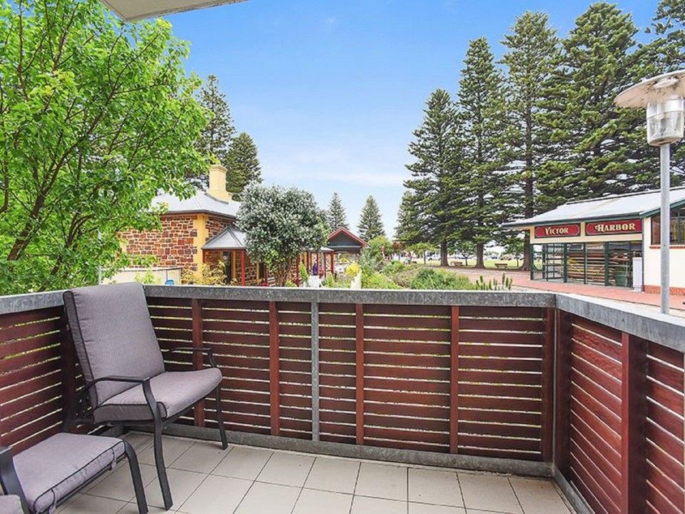 Spacious balcony shaded by iconic pine trees—ideal for morning coffees or sunset wines.
