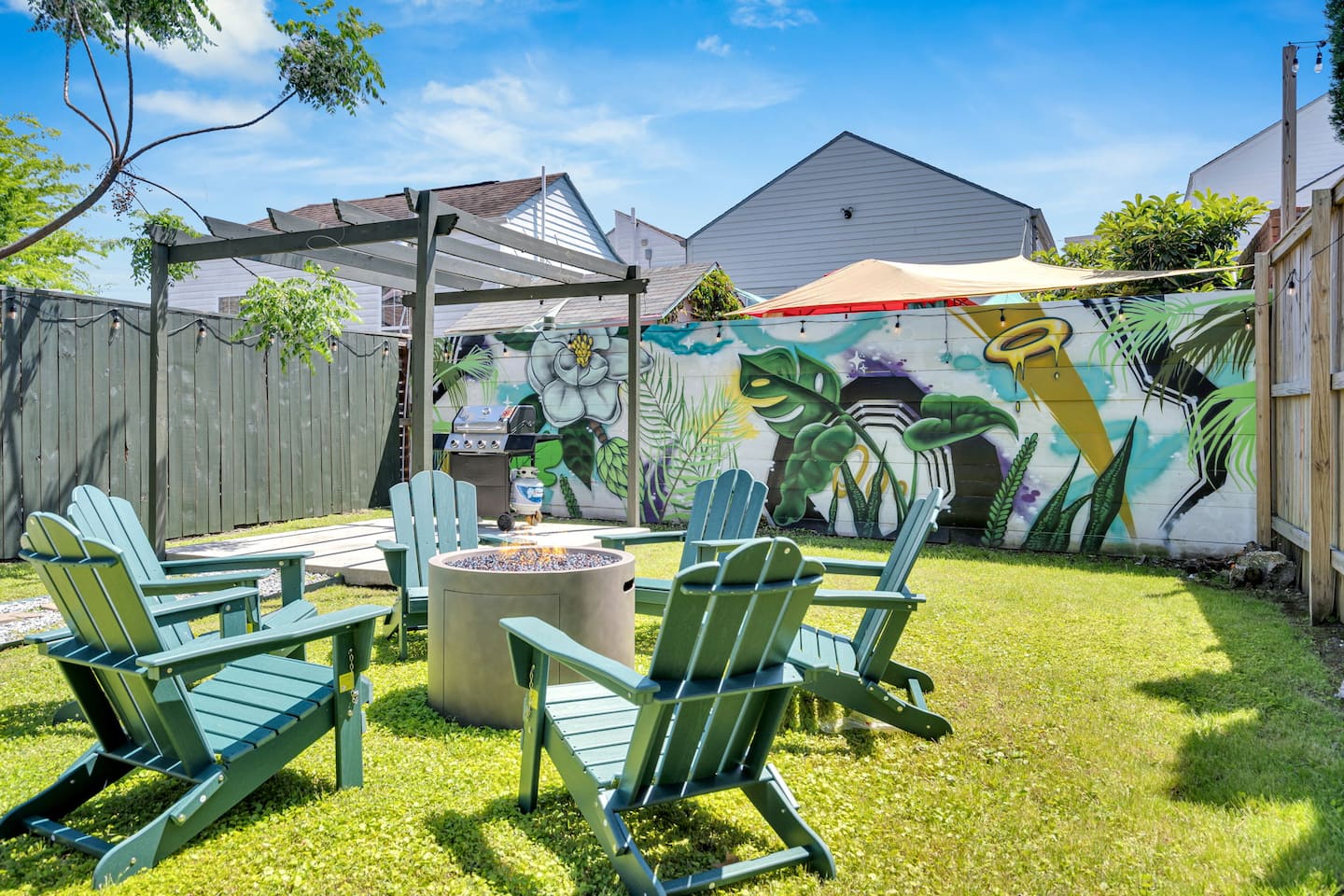 Bywater backyard vibes—fire pit, mural, and good times waiting.