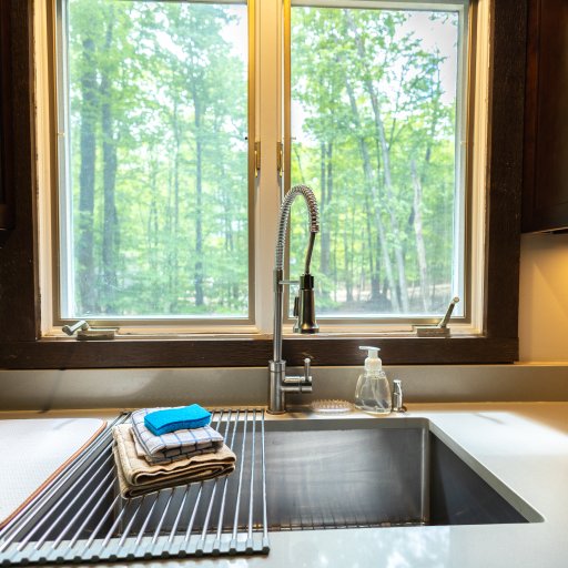 Wash up with a view—enjoy the serene woodland scenery through the kitchen window