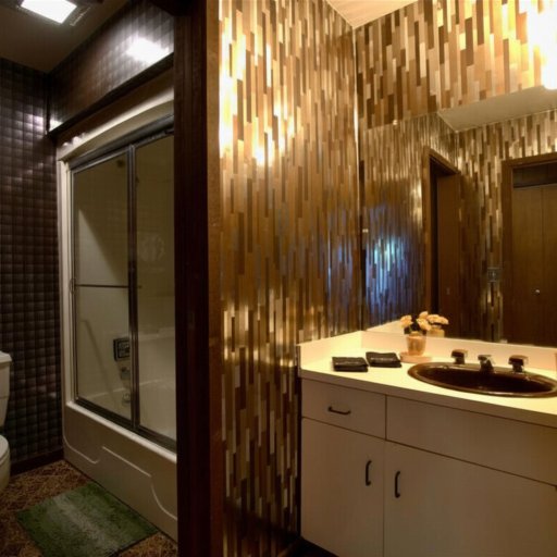 Full bath with gold tile, tub-shower, and vanity