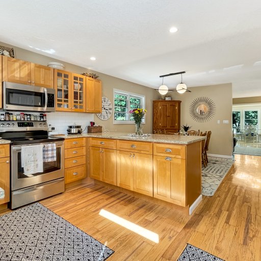 Fully stocked eat in Kitchen -looking into the living room and sunroom - main level