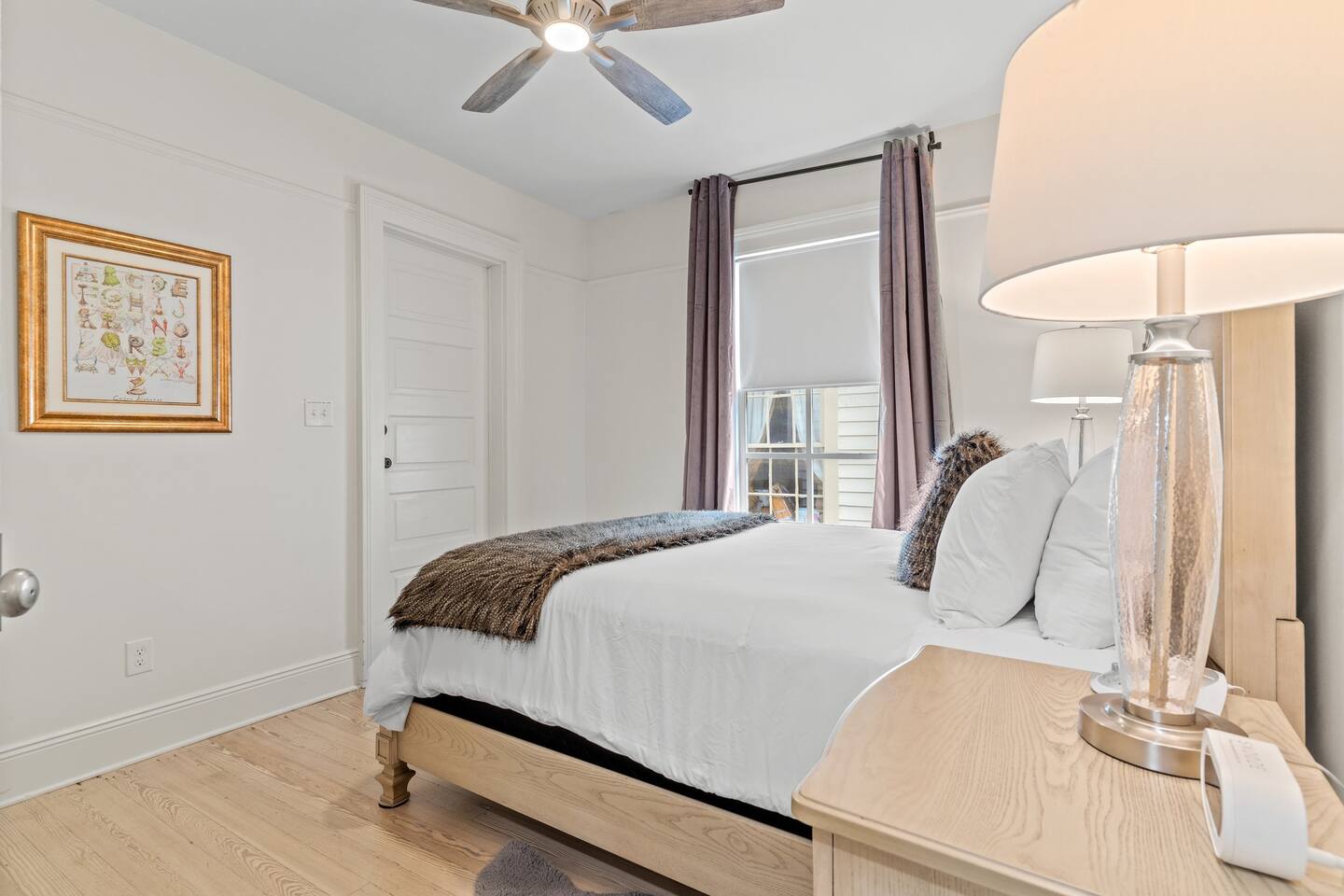 First bedroom with overhead light and lamps for ample lighting!