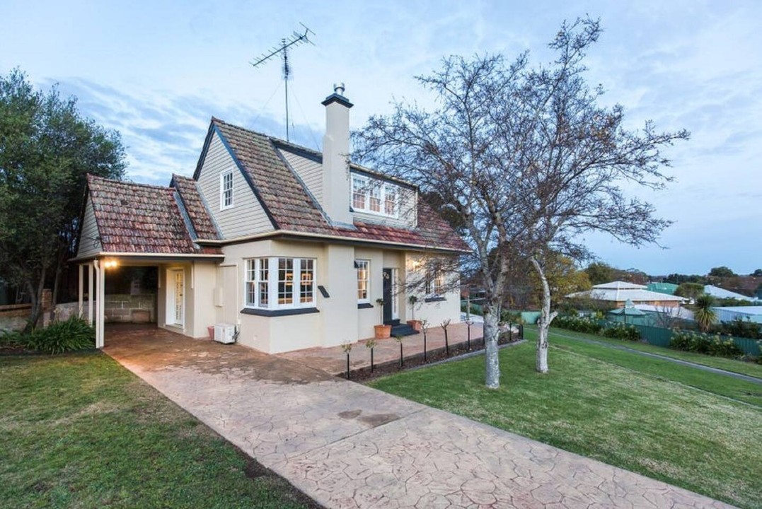 Generous backyard with carport, wood shed, garden shed, and full vehicle access.