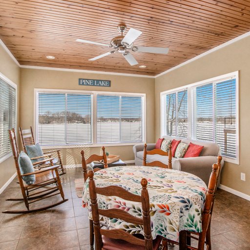 Sunroom dining table for four with panoramic lake views