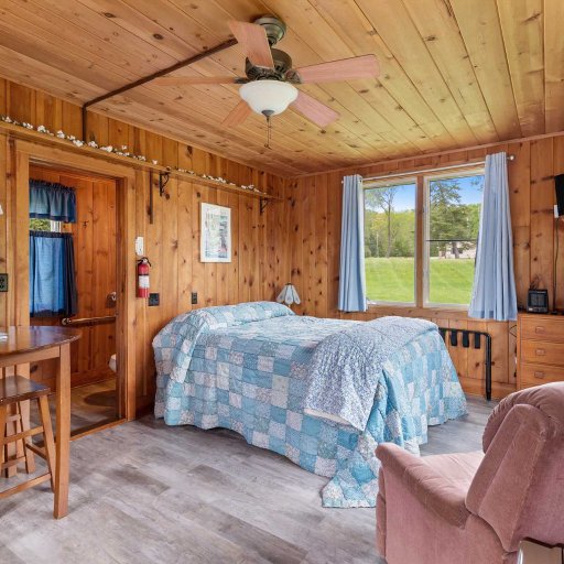 Cozy studio-style interior with sleeping, sitting, and kitchenette space designed for comfort and quiet mornings.