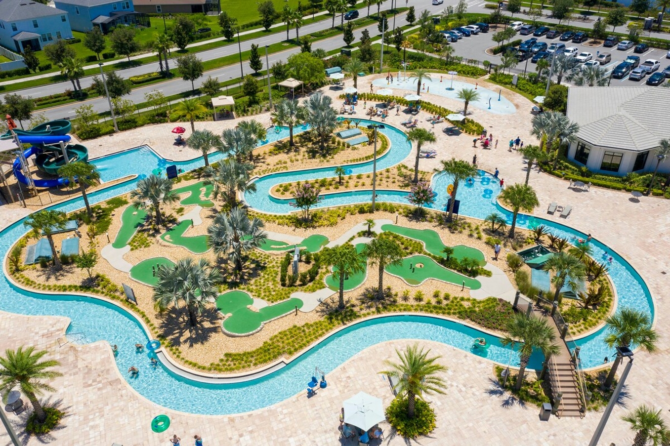 The lazy river with a mini golf in the middle decorated with palms. 