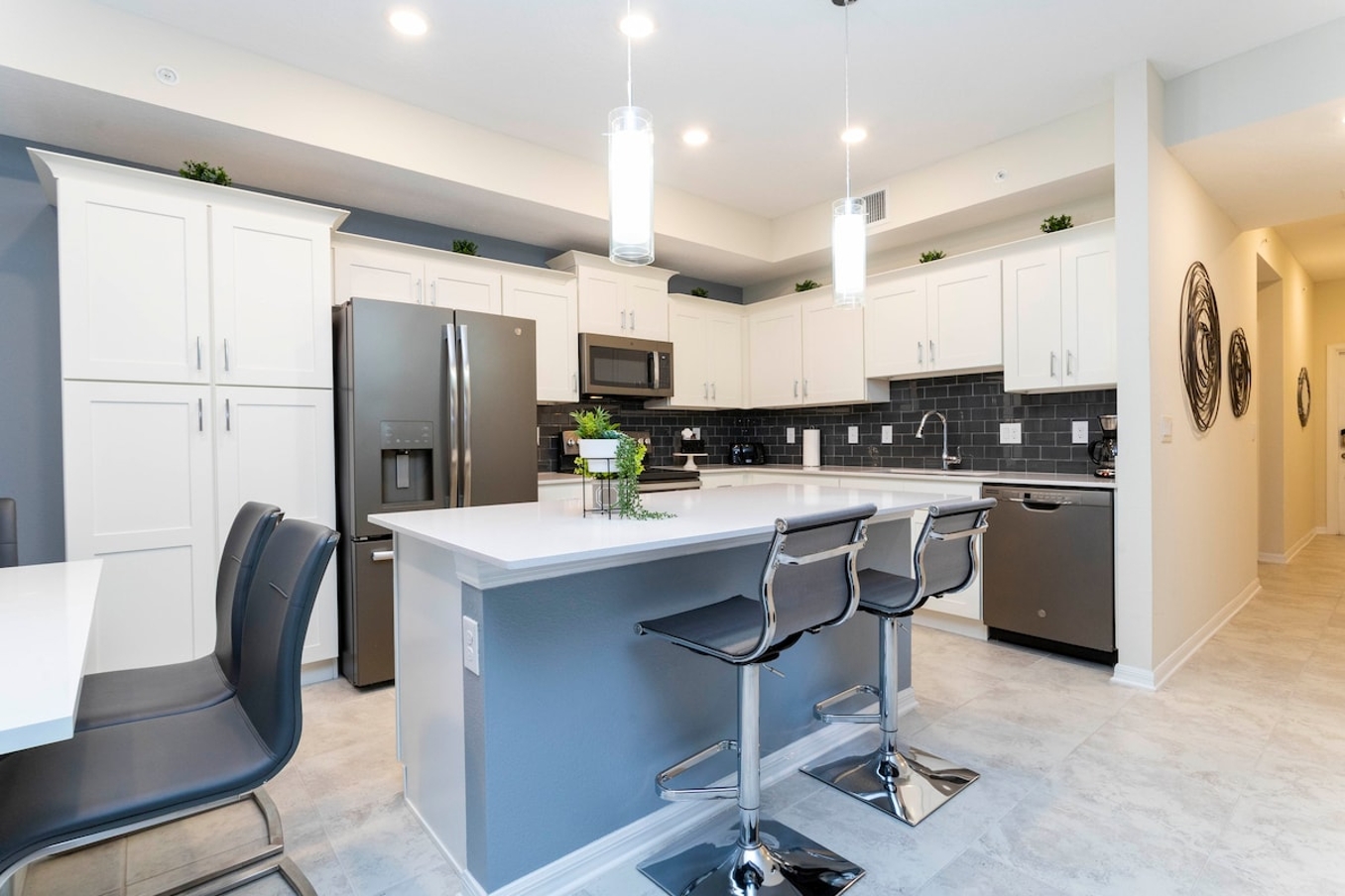 The fully equipped kitchen features modern appliances, sleek cabinetry, and all essential cookware and utensils, making it perfect for preparing meals with ease.