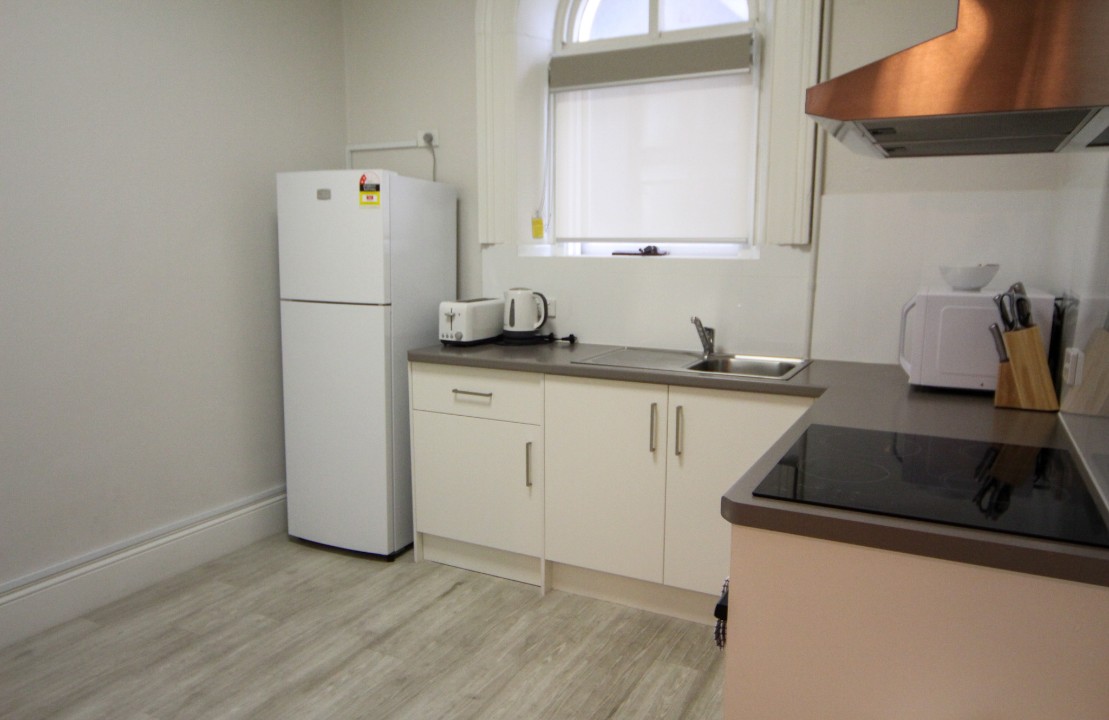 Open plan lounge, dining, and kitchen areas with smart TV, free WiFi, split system air conditioning, modern kitchens, and refurbished bathrooms in each unit featuring contemporary fixtures for guest comfort.